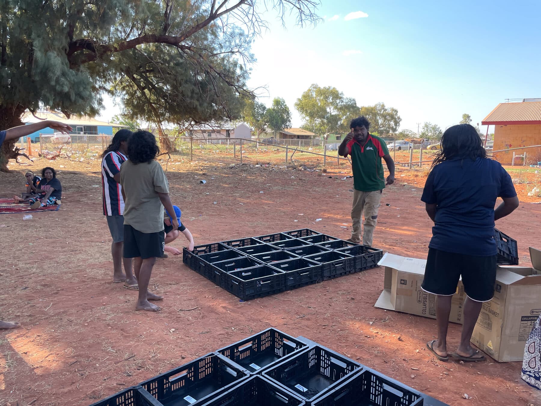 Community members assembling Stretch Beds at Utopia Homelands