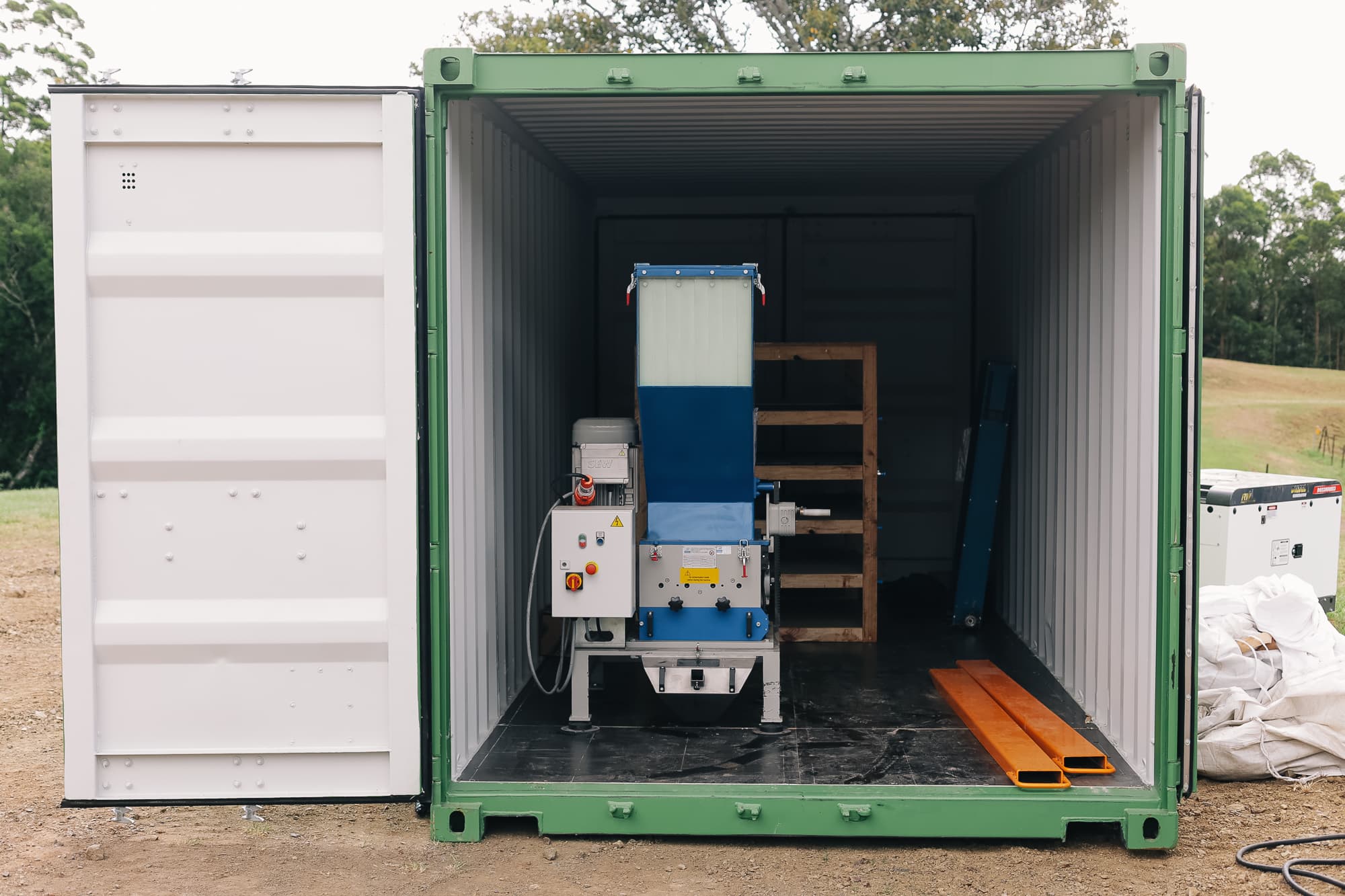 Plastic shredder inside containerised production plant
