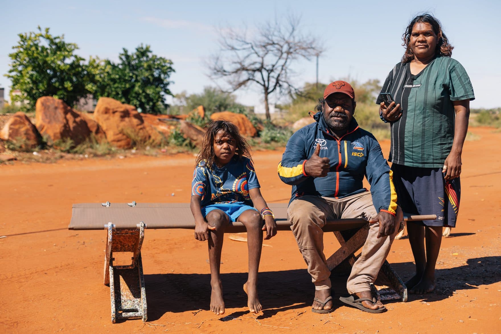 A family on a Stretch Bed, up off the ground, Utopia Homelands
